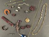 various necklaces and bracelets laid out on a table