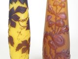two vases sitting next to each other on a white surface