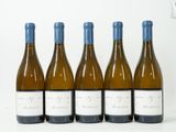 quatre bouteilles de vin sont alignées sur une table