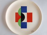 a white plate with a red, blue, and green design on it
