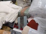 a pile of clothes and other items in a shopping cart