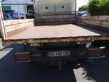 an image of a flat bed truck parked in a parking lot