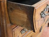 a wooden dresser with a drawer on top of it