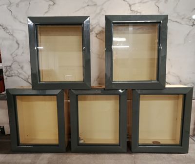 four glass display cases are stacked on top of each other in a room