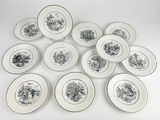 six plates with black and white designs are arranged on a white surface