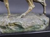 a statue of a man riding a horse on top of a rock