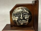 an image of a bookend with a face on it
