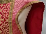 an image of a mannequin wearing a red and gold dress