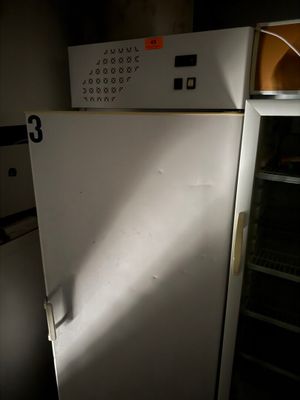a white refrigerator in a dark room with the door open
