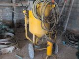 a yellow machine that is sitting in a garage