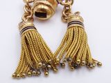 pair of gold tone tassels with black and white beads