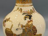 a white vase with a picture of a woman riding a horse
