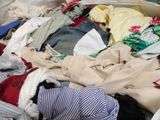 a pile of clothes that is sitting on the floor