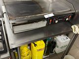 a commercial kitchen with a stove, oven, and other appliances