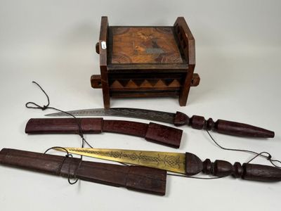 plusieurs types de couteaux et une boîte en bois posés sur une table