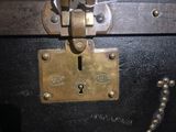 a close up of a metal lock on a black suitcase