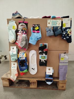 many pairs of socks on a pallet in a room