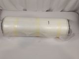 a roll of tape wrapped in plastic on a white surface