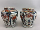 pair of chinese vases with floral designs on them on a white surface