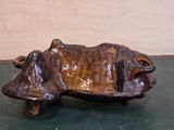 a statue of a cow that is sitting on a table