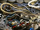 a pile of jewelry on a table with rocks