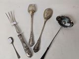 several spoons, forks, and spoon rest on a white surface