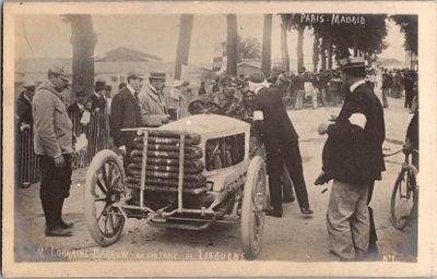 an old photo of a group of men standing around a car