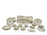 a lot of white and gold plates and bowls