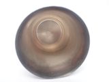 underside view of a brown glass vase on a white surface