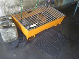 a metal grate on the floor next to a gas can
