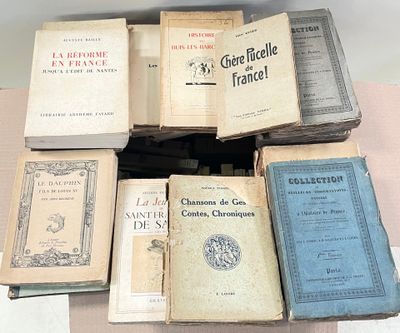 several old books are stacked on top of each other on a table