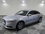 the silver audi is parked in a large room with a checkered floor