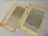 two pages of a book with writing on them sitting on a table