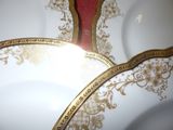 a close up of a plate with a gold border