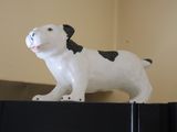 a statue of a dog on top of a refrigerator