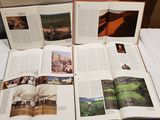 several open books sitting on top of a white table next to each other