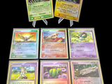 several pokemon cards are displayed on a black surface