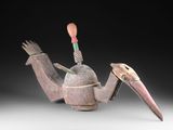 un gros plan sur une sculpture représentant un oiseau posée sur une table