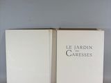 two books sitting on top of a white table next to each other