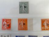 many different stamps on a display in a glass case