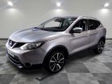 the silver nissan suv is parked on a checkered tile floor