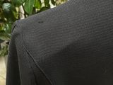 a close up of a person wearing a black suit and tie