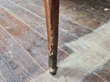 a wooden table with a wooden top on a hard wood floor