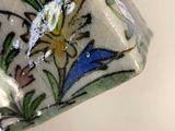 a close up of a vase with a flower design on it