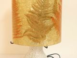 a lamp that is sitting on a table with a lamp shade on it