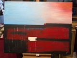 un tableau représentant un tableau rouge et bleu posé sur un chevalet