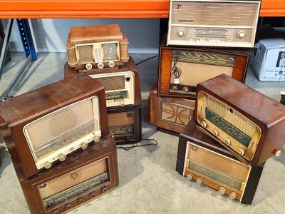 four old fashioned radio ' s stacked on top of each other