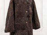 a close up of a brown coat on a mannequin stand