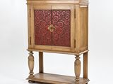 a wooden cabinet with a red and gold design on it