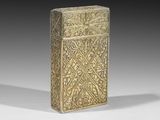 an old brass cigarette case with a design on the front